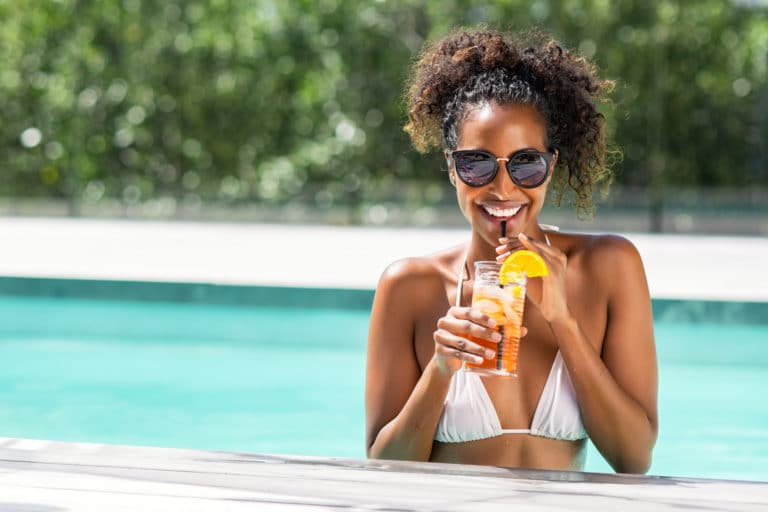 Portrait,Of,Happy,Fashion,Woman,With,Sunglasses,Standing,In,Swimming